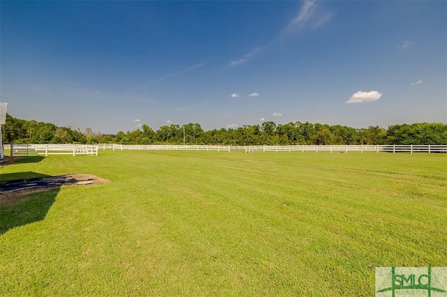 view of yard featuring fence and a rural view