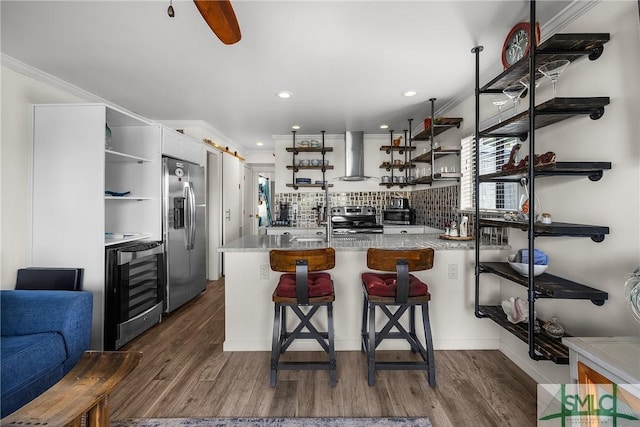 kitchen with crown molding, open shelves, stainless steel appliances, dark wood-type flooring, and wall chimney exhaust hood