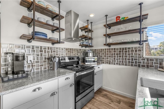 kitchen featuring stainless steel range with electric stovetop, white cabinetry, island range hood, and open shelves