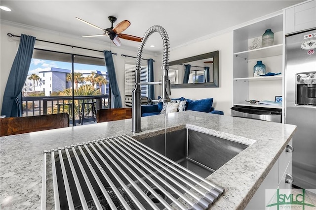 kitchen featuring white cabinetry, crown molding, stainless steel refrigerator with ice dispenser, and light stone countertops