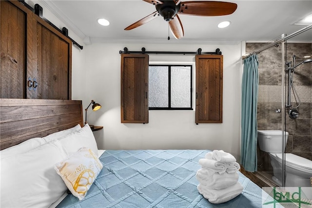 bedroom with a barn door, a ceiling fan, and crown molding