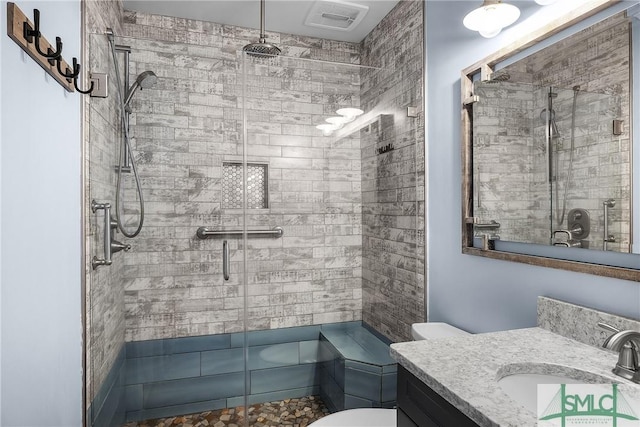 full bathroom featuring toilet, a shower stall, visible vents, and vanity