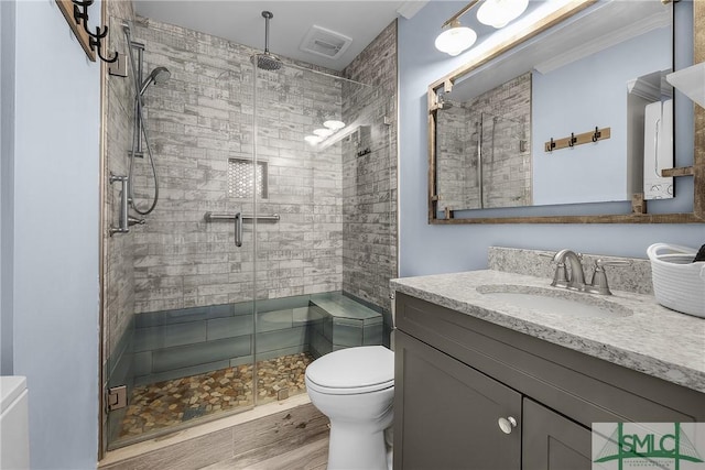 bathroom featuring a stall shower, visible vents, vanity, and toilet