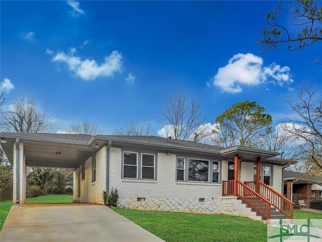 ranch-style home featuring brick siding, a front yard, crawl space, an attached carport, and driveway