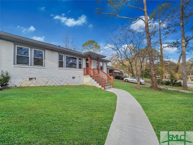 view of front facade with crawl space, a front yard, and brick siding