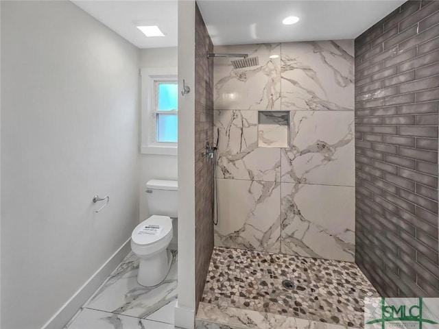 full bath featuring toilet, marble finish floor, a marble finish shower, and baseboards