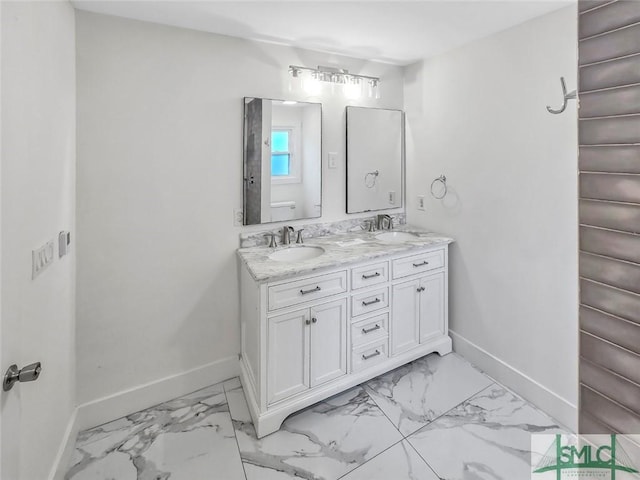 bathroom featuring marble finish floor, a sink, baseboards, and toilet