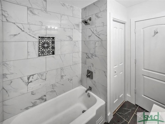 bathroom with marble finish floor and bathtub / shower combination