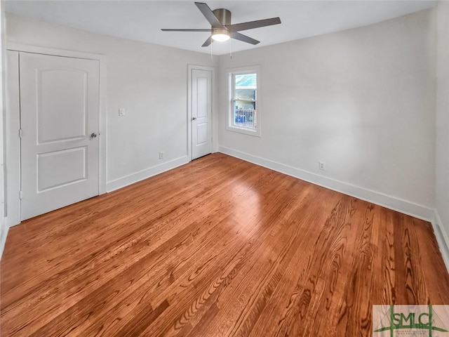 unfurnished bedroom with light wood-type flooring, ceiling fan, and baseboards