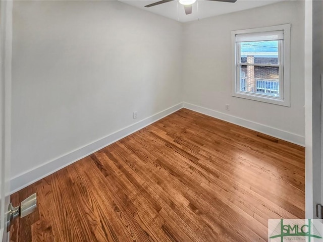 unfurnished room featuring a ceiling fan, visible vents, baseboards, and wood finished floors