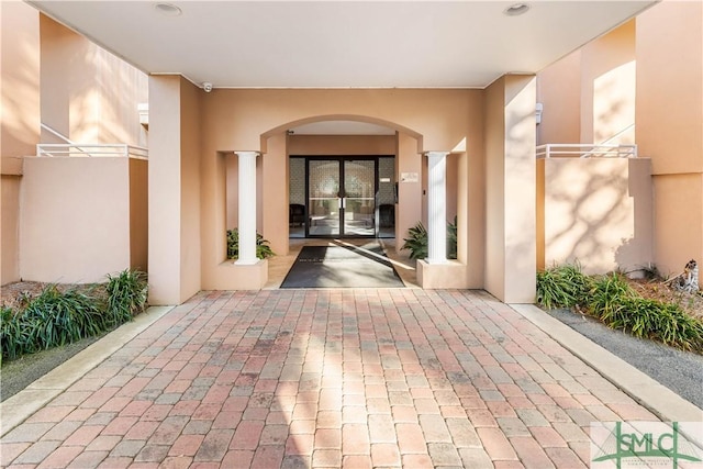 property entrance with stucco siding