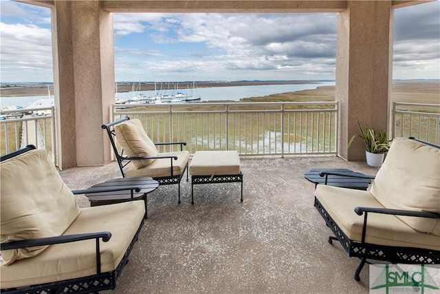 balcony with a water view and outdoor lounge area