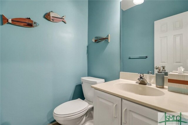 bathroom featuring toilet and vanity