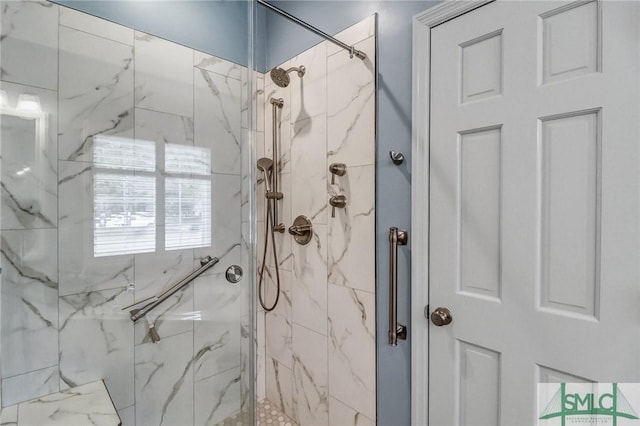 bathroom with a marble finish shower