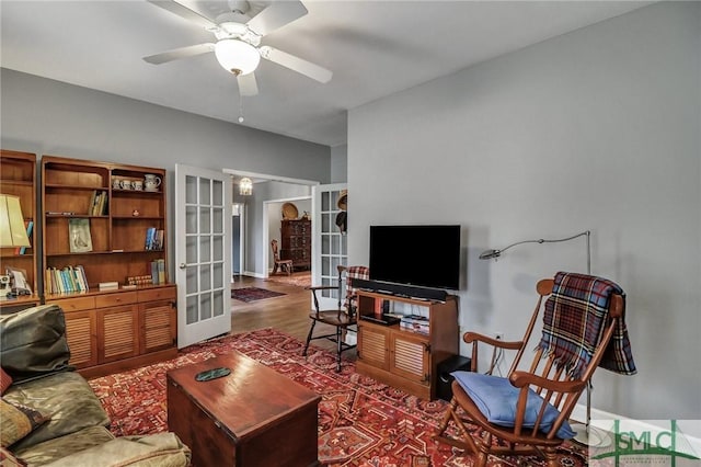 living room with a ceiling fan, french doors, and wood finished floors