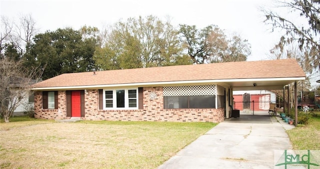 ranch-style home featuring a carport, a front yard, concrete driveway, and brick siding