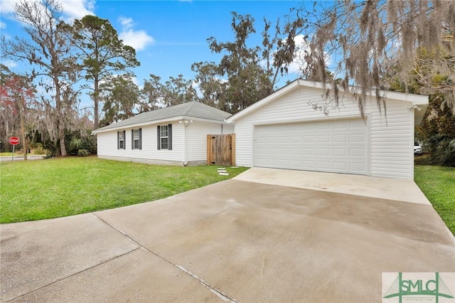 ranch-style home featuring a garage, an outdoor structure, and a front yard