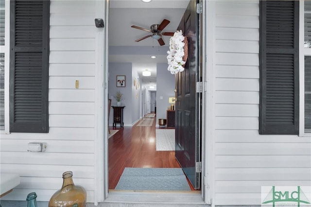 view of exterior entry featuring ceiling fan