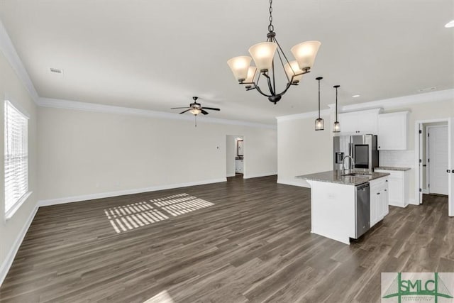 kitchen with stainless steel appliances, white cabinetry, open floor plan, a center island with sink, and decorative light fixtures