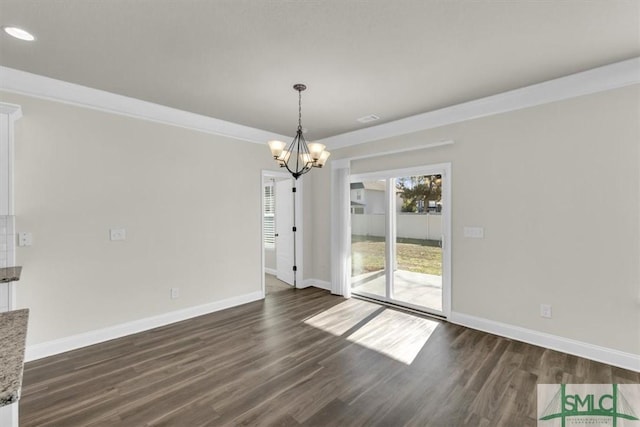 unfurnished dining area with dark wood-style floors, a notable chandelier, and baseboards