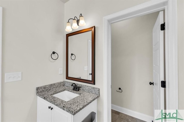 bathroom with vanity and baseboards