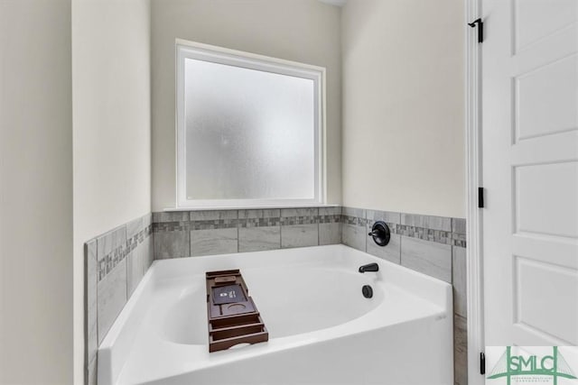 full bath featuring plenty of natural light and a bath