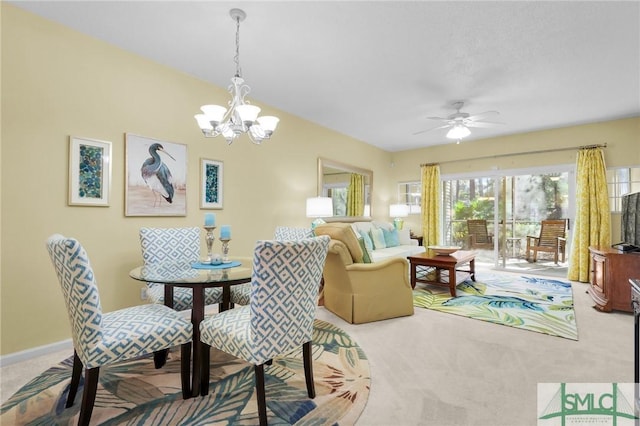 dining area featuring carpet, baseboards, and ceiling fan with notable chandelier