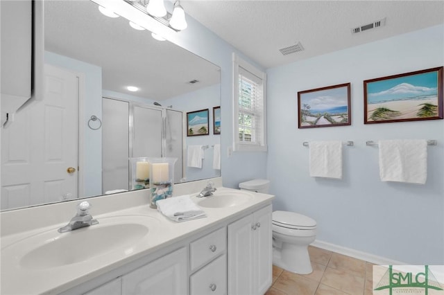 full bathroom featuring visible vents, a sink, and a shower stall