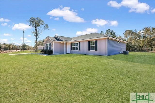 view of front of house featuring a front lawn and cooling unit