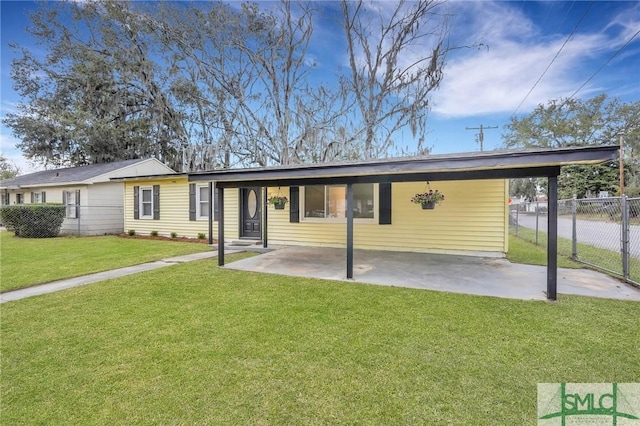 exterior space featuring fence, a yard, and an attached carport