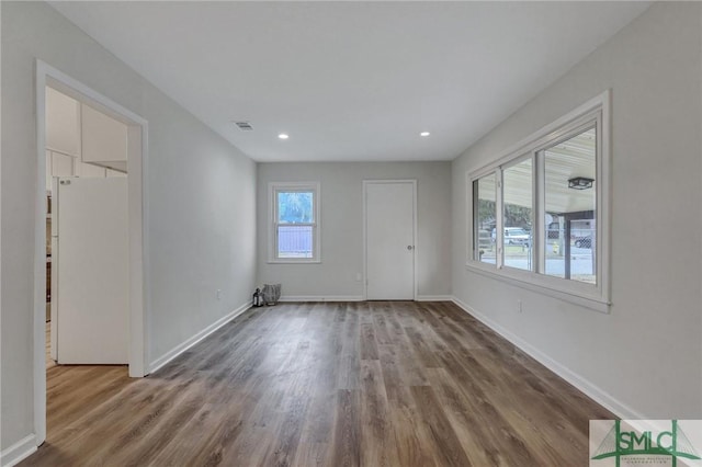 interior space with baseboards, visible vents, and a wealth of natural light