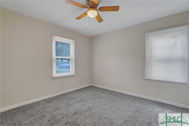 empty room featuring light carpet, ceiling fan, and baseboards