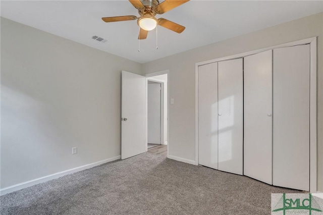 unfurnished bedroom featuring baseboards, visible vents, carpet, a ceiling fan, and a closet