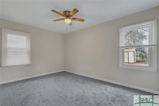 empty room featuring ceiling fan, carpet, and baseboards