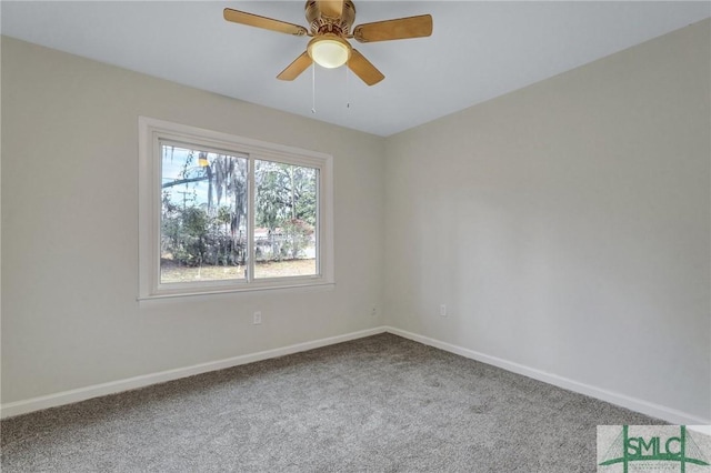carpeted empty room featuring a ceiling fan and baseboards