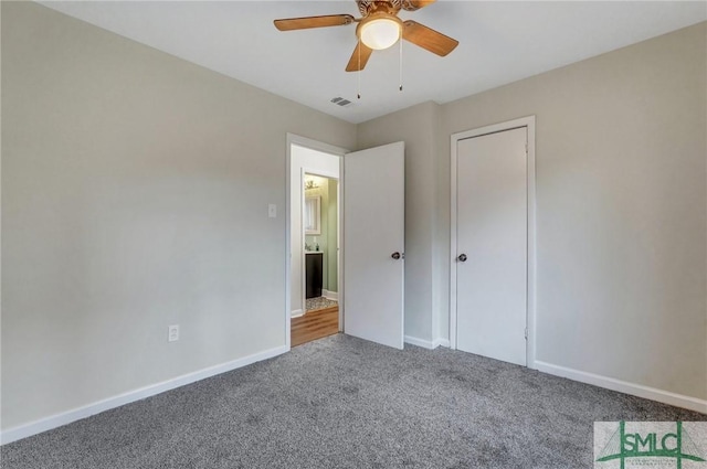 unfurnished bedroom featuring a ceiling fan, carpet, visible vents, and baseboards