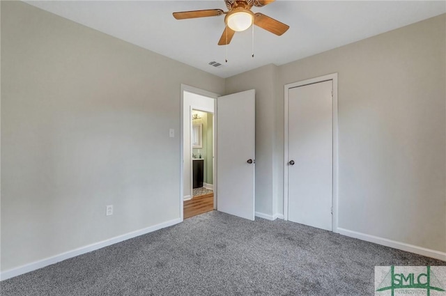 unfurnished bedroom featuring carpet, visible vents, baseboards, and ceiling fan