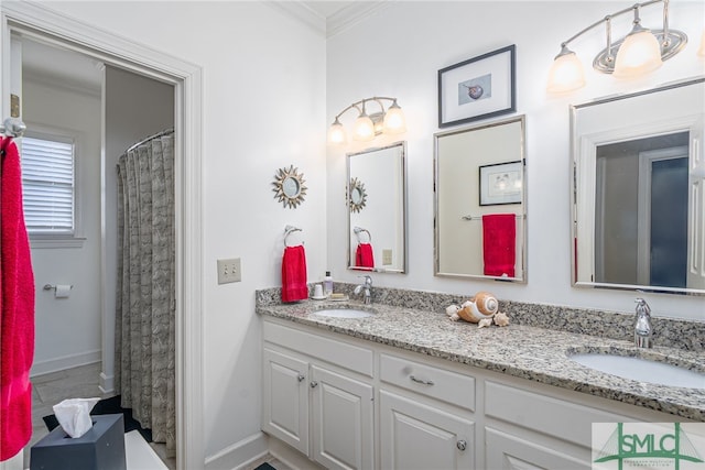 bathroom featuring crown molding, a sink, baseboards, and double vanity