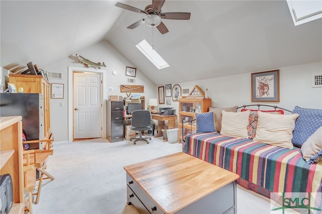 living room featuring vaulted ceiling with skylight, visible vents, a ceiling fan, and light colored carpet