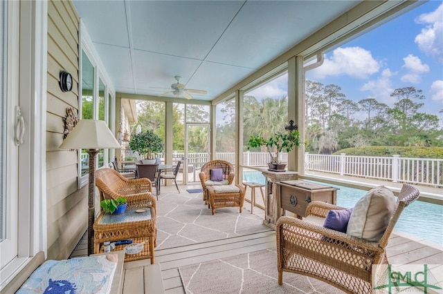 sunroom / solarium featuring ceiling fan