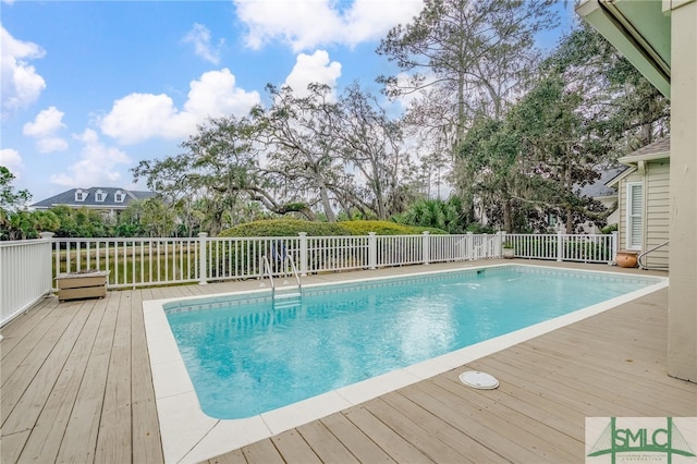 view of swimming pool featuring a fenced in pool and a wooden deck