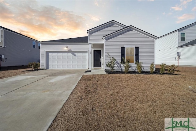 ranch-style house with concrete driveway, a yard, and an attached garage