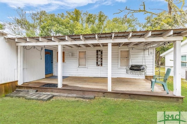 exterior space with fence and a lawn