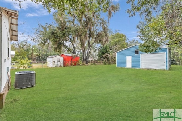 view of yard featuring fence, a storage unit, cooling unit, and an outbuilding