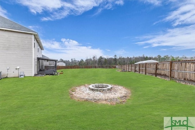 view of yard featuring an outdoor fire pit, a sunroom, a fenced backyard, and cooling unit