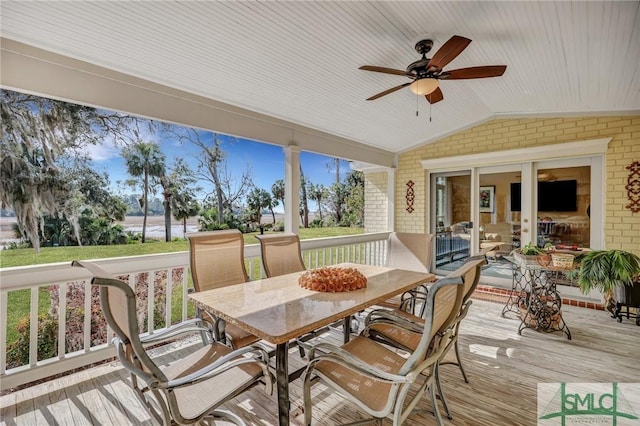 wooden deck with ceiling fan and outdoor dining area