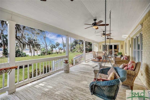 wooden deck with a yard, french doors, ceiling fan, and an outdoor hangout area