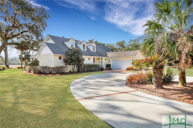 cape cod house with a garage, concrete driveway, and a front yard