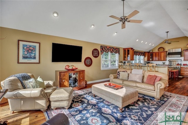 living room featuring vaulted ceiling, ceiling fan, and dark wood finished floors