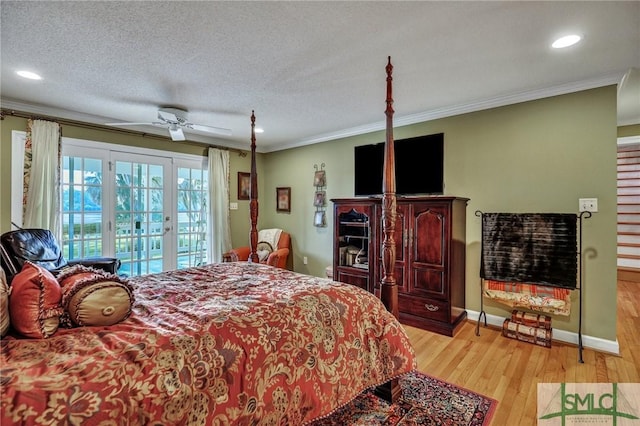 bedroom featuring access to exterior, french doors, crown molding, and light wood-style floors